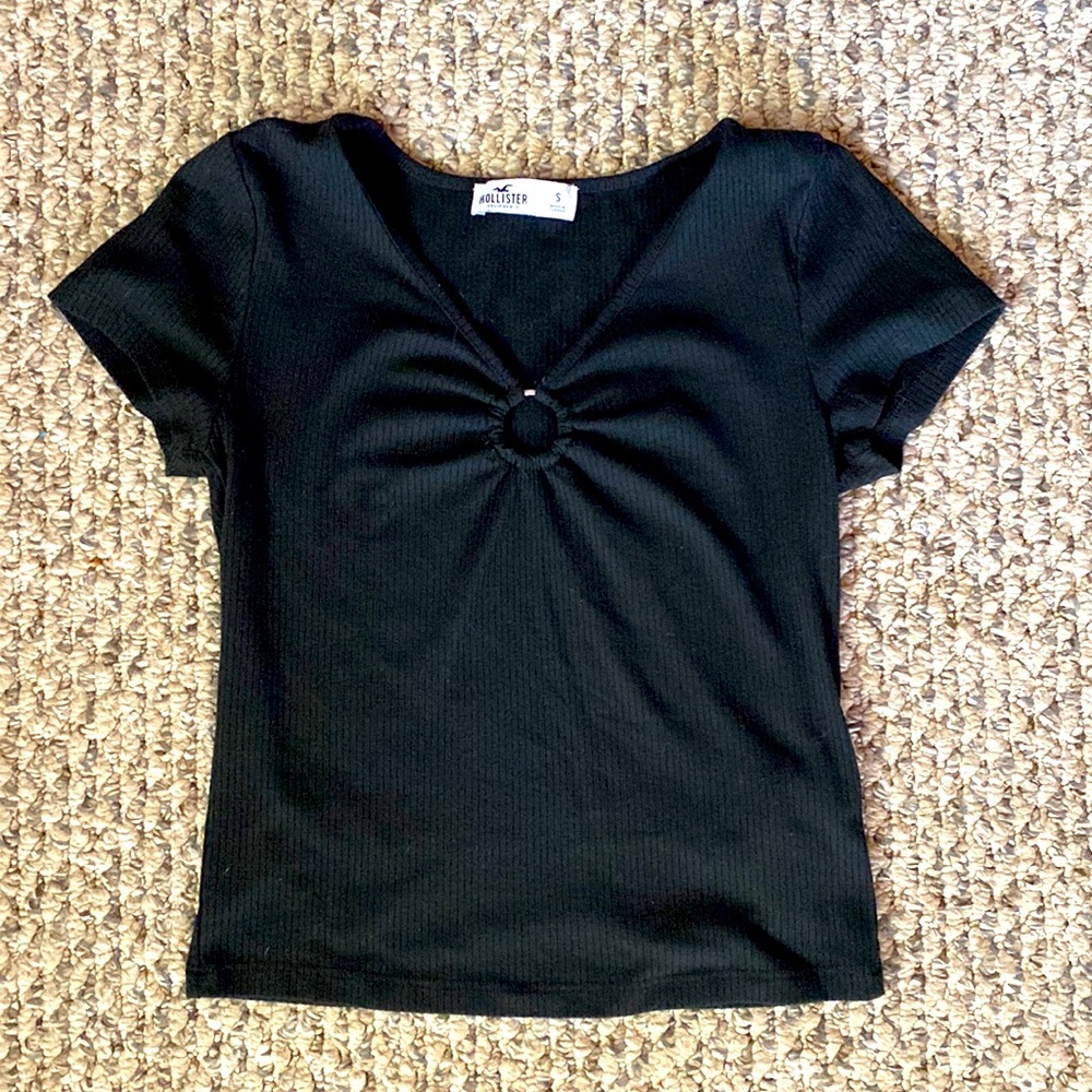 A soft black shirt with a metal ring in the front